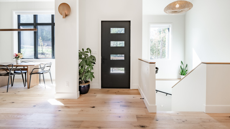 Engineered wood floors in an entryway without any mats and rugs