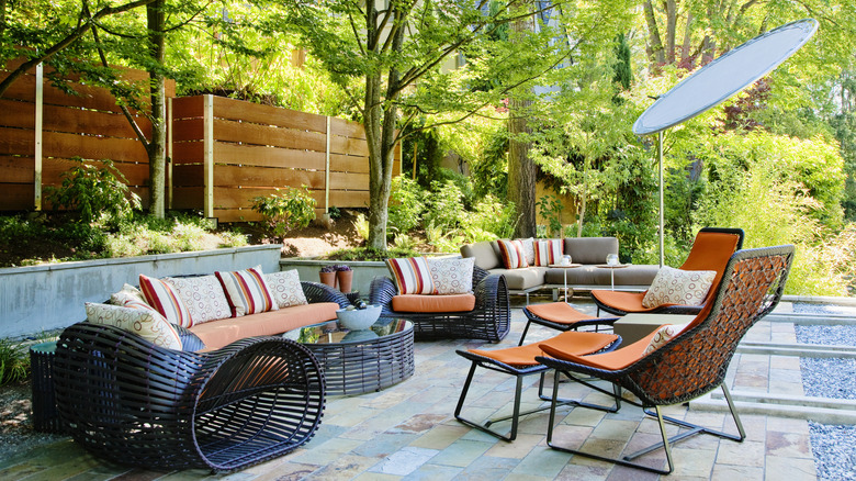 Patio furniture with orange cushions in outdoor space