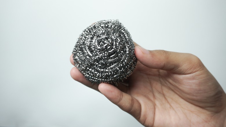 Holding ball of steel wool