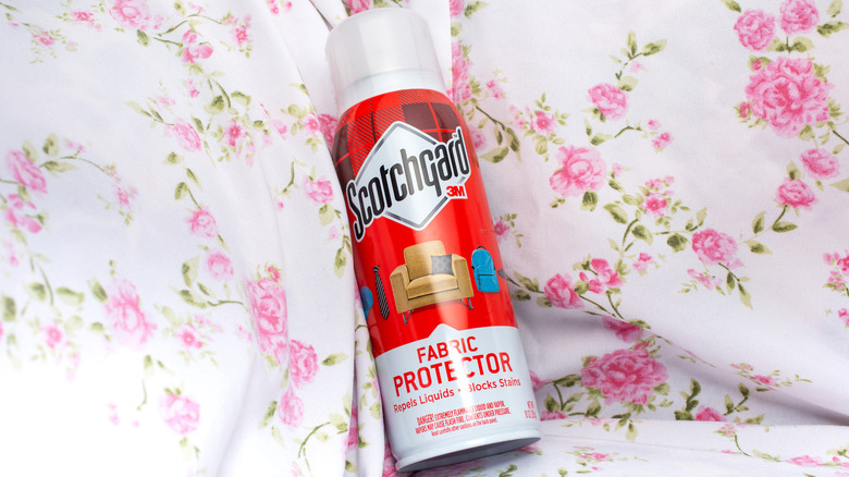 A view of a container of 3M Scotchgard fabric protector in a corner of a covered couch