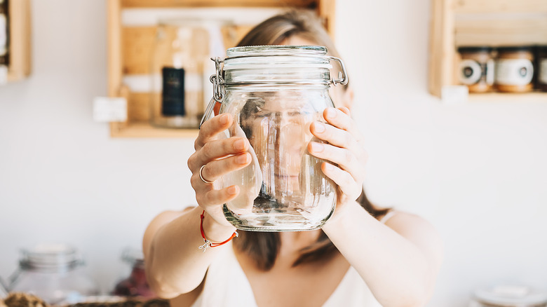 Woman holding glass jar