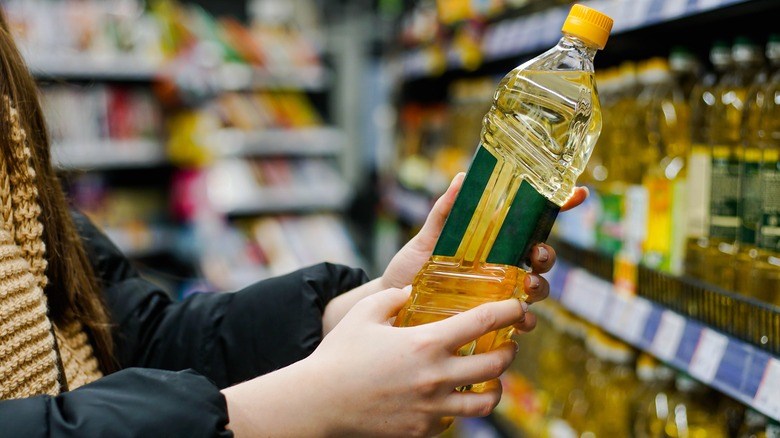 Woman holding cooking oil 