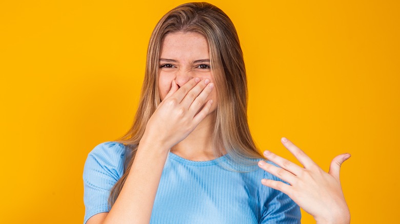 Woman covering her nose