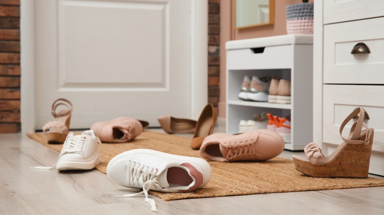 messy entryway with shoes on the floor