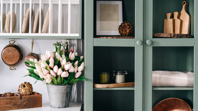Green vintage cupboard with glass doors