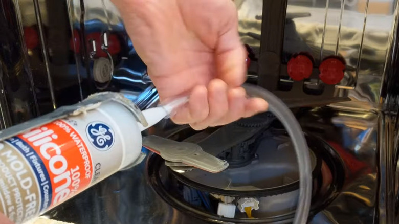 Attaching tubing to sealant nozzle