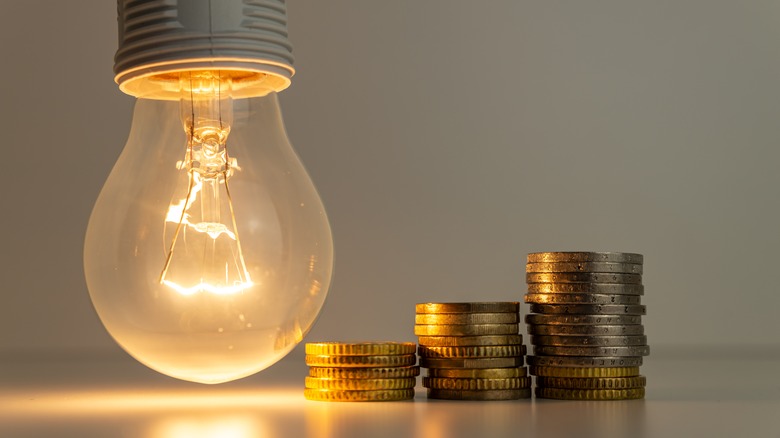 light bulb next to coins