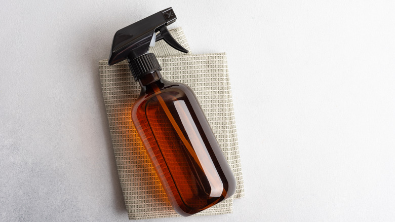 brown spray bottle and cloth 