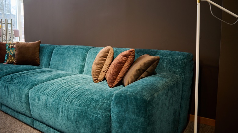 teal couch against wall