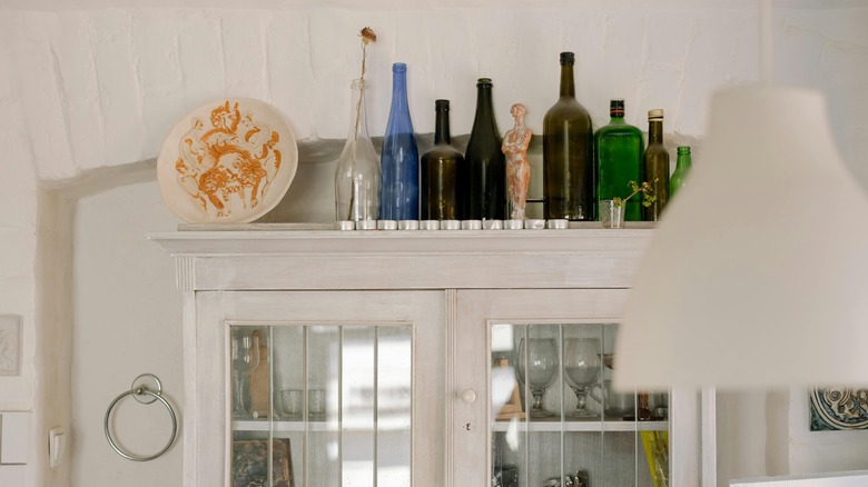 Wine glasses above kitchen cabinet