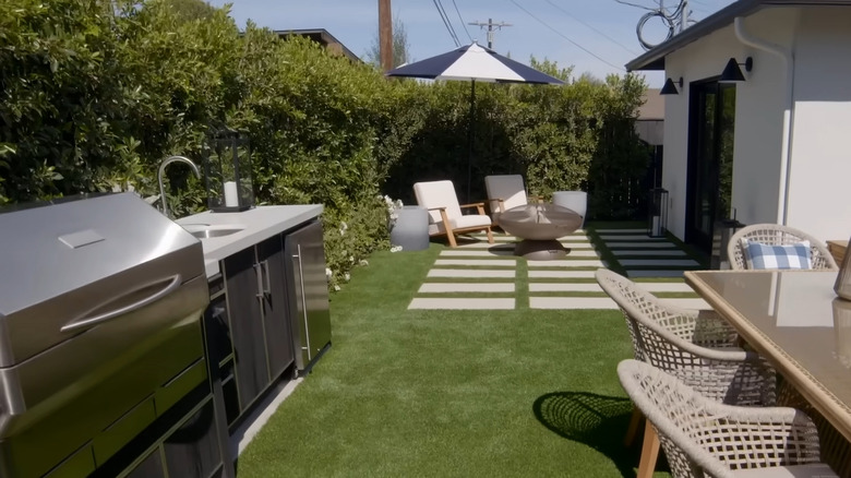 Made-over backyard with lush privacy hedge and outdoor furniture in finale of of Season 6, "Brother vs. Brother"