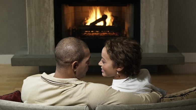 Cople in front of fireplace