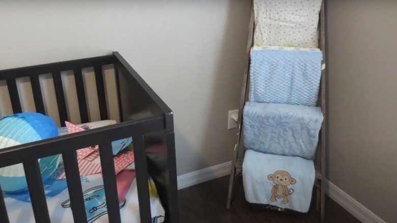 nursery with blanket holder and crib