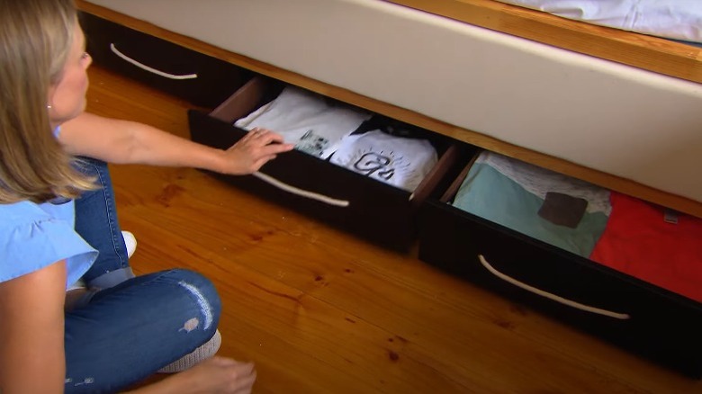 woman organizing underbed storage drawers