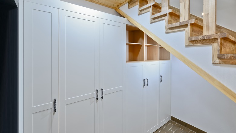 white cabinet pantry under stairs