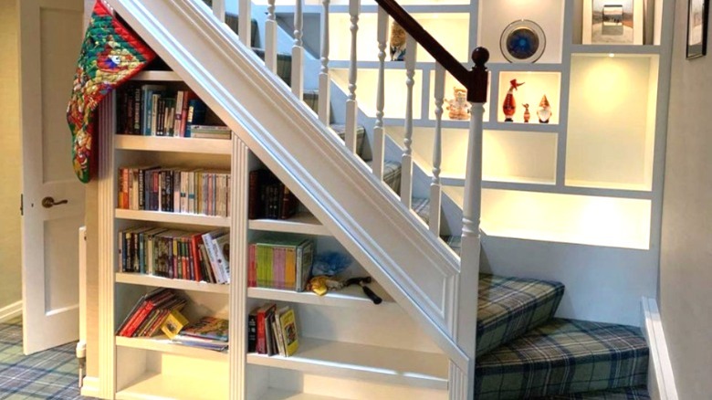 whitw bookshelf under stairs