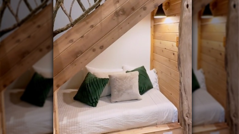 bed under wood staircase