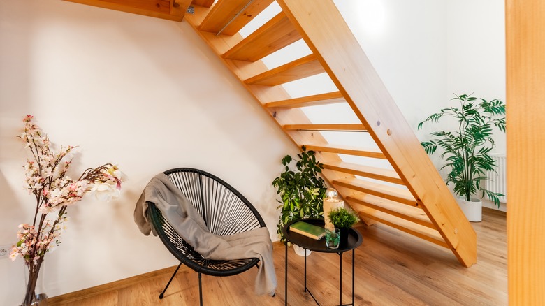 furniture under warm wood staircase