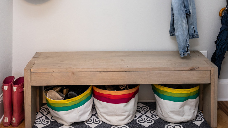 Hampers under mudroom bench