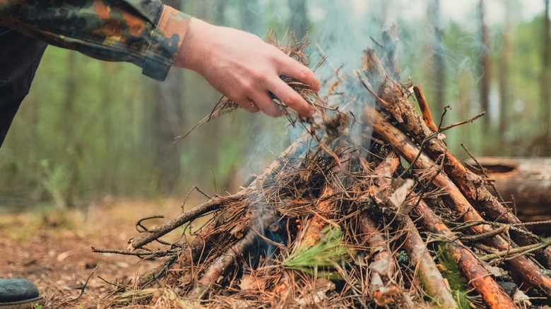 Person starting outdoor fire