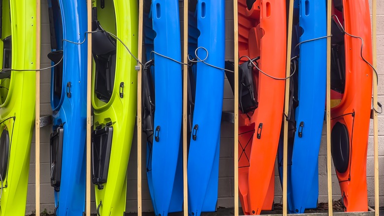 Colorful kayaks stored on end