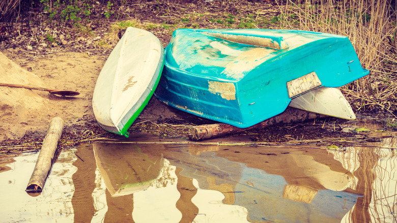 Kayak and boat on shore