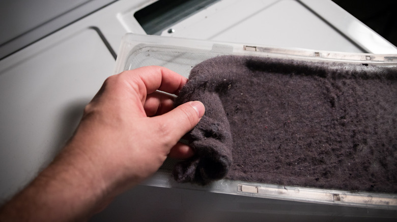 man collecting dryer lint