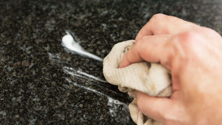 Wiping down granite countertop