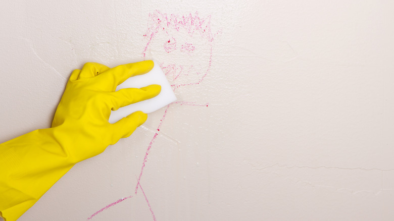 Scrubbing crayon marks from the wall