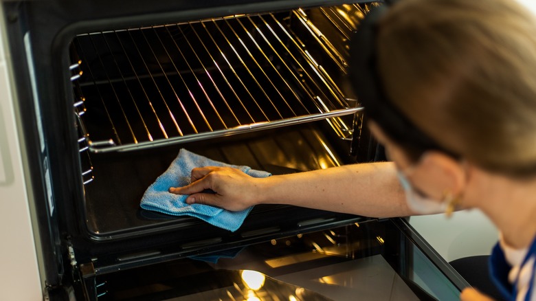 Woman cleaning an oven