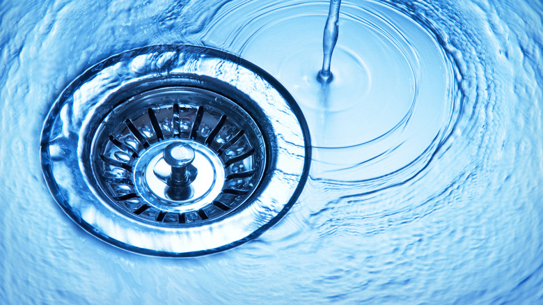 Close-up of water going down a drain