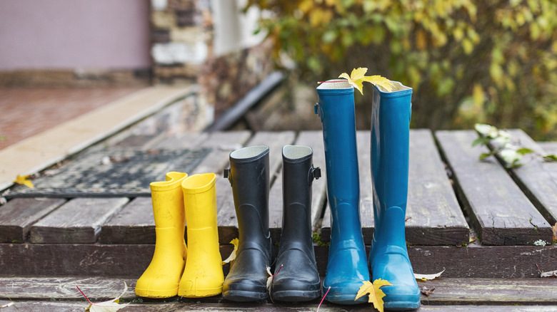 three pairs of rainboots outside