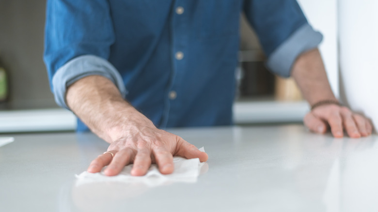 man cleaning counter