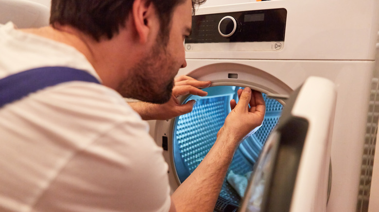 Man repairing dryer seal