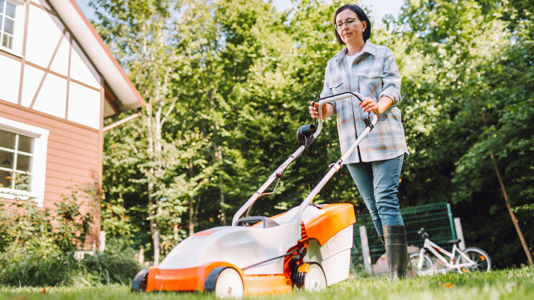 woman mowing lawn