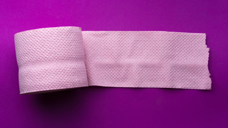 pink toilet paper purple background