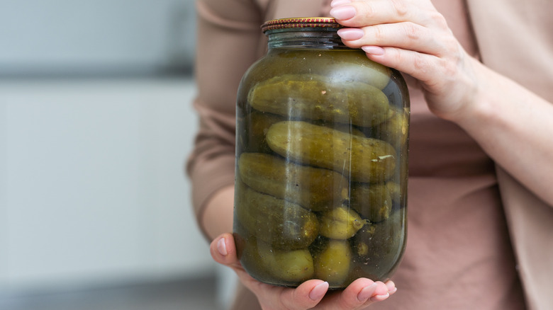 Woman holding pickle jar