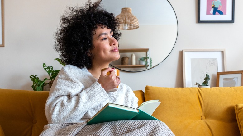 Woman sitting on sofa smiling 