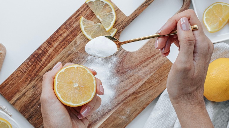 Holding lemon before a fridge