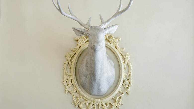 mounted stag head wall sculpture in ornate frame