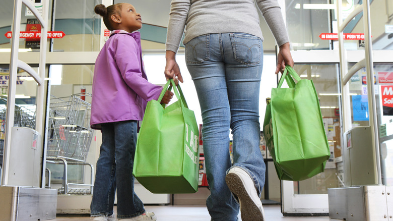 Mother and daughter using reusable shopping bags