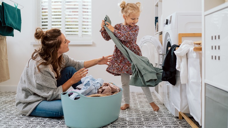 Woman and daughter doing laundry