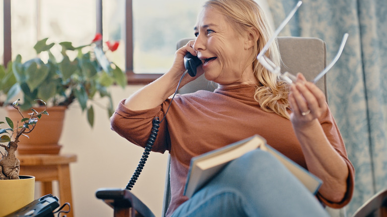 woman talking on corded phone