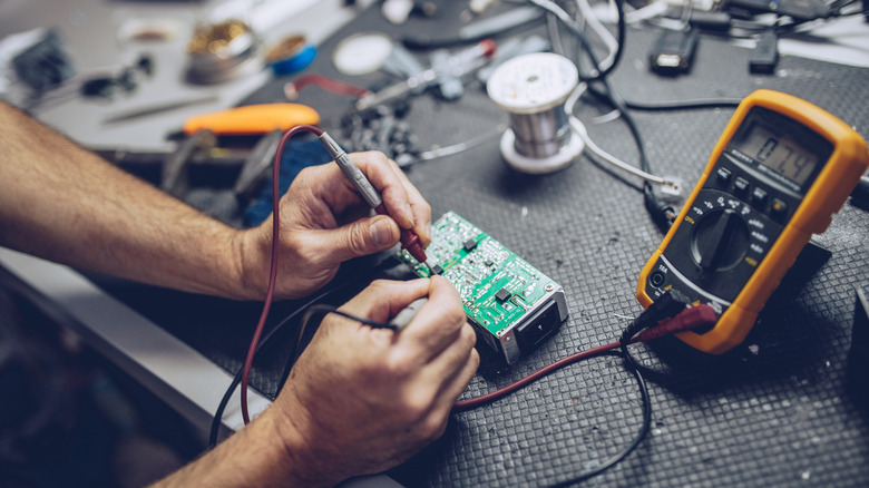 person fixing electricals