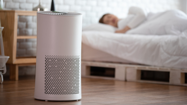 woman sleep with Air purifier in cozy white bed room