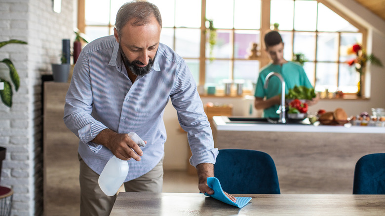 Man wiping table