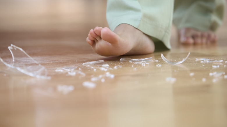 broken glass near bare feet