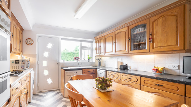 Natural wood cabinets and a matching table in a kitchen