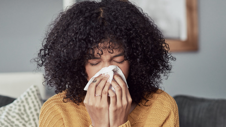 woman blowing her nose