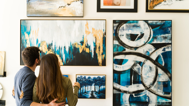 Couple looking at home gallery wall